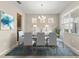 Formal dining room with seating for six, modern chandelier, and a large window at 3148 Marine Grass Dr, Wimauma, FL 33598