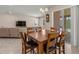 Dining room with wood table and chairs, and sliding glass doors to outdoor pool area at 3148 Marine Grass Dr, Wimauma, FL 33598