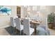 Dining room with seating for six, neutral wall color, and a large window at 3148 Marine Grass Dr, Wimauma, FL 33598
