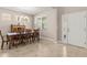 Traditional dining room featuring a wooden table with seating for six and decorative front door at 3148 Marine Grass Dr, Wimauma, FL 33598