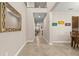 Bright entryway featuring neutral walls, tile floors, and a decorative mirror, creating a welcoming first impression at 3148 Marine Grass Dr, Wimauma, FL 33598