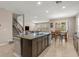 Open kitchen featuring granite countertops, a central island, and stainless steel appliances at 3148 Marine Grass Dr, Wimauma, FL 33598