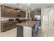 Spacious kitchen featuring granite countertops, stainless steel appliances, a large island, and plenty of storage at 3148 Marine Grass Dr, Wimauma, FL 33598