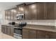 Kitchen featuring granite countertops, stainless steel appliances, and ample cabinet space for storage at 3148 Marine Grass Dr, Wimauma, FL 33598