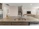 Kitchen island with granite countertops, stainless steel appliances, and easy access to the laundry and living rooms at 3148 Marine Grass Dr, Wimauma, FL 33598