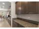 Kitchen with granite countertops and dark wood cabinetry at 3148 Marine Grass Dr, Wimauma, FL 33598
