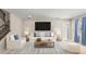 Living room featuring a white sofa, accent chair, and large TV at 3148 Marine Grass Dr, Wimauma, FL 33598