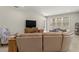 Living room with leather sectional sofa and large TV at 3148 Marine Grass Dr, Wimauma, FL 33598