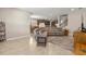 Living room with leather sectional sofa, and open layout to kitchen and dining room at 3148 Marine Grass Dr, Wimauma, FL 33598