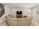 Living room with leather sectional sofa and large TV at 3148 Marine Grass Dr, Wimauma, FL 33598
