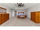 The primary bedroom has neutral colors, a ceiling fan, and lots of space at 3148 Marine Grass Dr, Wimauma, FL 33598