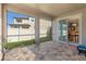 A covered patio offers a view of the yard and features a glimpse into the eat-in kitchen at 3148 Marine Grass Dr, Wimauma, FL 33598