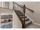 Elegant staircase with carpeted steps and decorative iron railing at 3148 Marine Grass Dr, Wimauma, FL 33598