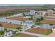 An aerial view of a waterfront home with palm trees and manicured landscaping at 3415 Croaker Dr, Hernando Beach, FL 34607