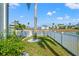 Backyard with a well-maintained lawn, white fence and water view at 3415 Croaker Dr, Hernando Beach, FL 34607