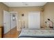 Bedroom with natural light, wood floors, closet space, and cozy decor at 3415 Croaker Dr, Hernando Beach, FL 34607