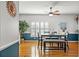 Cozy dining area with natural light, wood floors, and a stylish ceiling fan at 3415 Croaker Dr, Hernando Beach, FL 34607