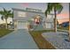 Two-story home with attached garages, well-kept front yard and a distinctive red front door at 3415 Croaker Dr, Hernando Beach, FL 34607