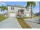 Inviting two-story home with a vibrant red door, a well-manicured lawn, and a convenient two-car garage at 3415 Croaker Dr, Hernando Beach, FL 34607