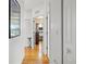 Hallway with hardwood floors leading to rooms, white doors, and stylish decorations at 3415 Croaker Dr, Hernando Beach, FL 34607