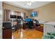 Home office with multiple monitors, wood floors, comfortable seating, and natural lighting at 3415 Croaker Dr, Hernando Beach, FL 34607
