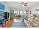 Living room featuring hardwood floors, ceiling fan, plush seating and sliding doors to the lanai at 3415 Croaker Dr, Hernando Beach, FL 34607