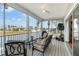 Relaxing screened porch with comfortable seating and a stunning waterfront view, perfect for outdoor enjoyment at 3415 Croaker Dr, Hernando Beach, FL 34607
