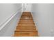Wooden staircase with white banister leads to the front door at 3415 Croaker Dr, Hernando Beach, FL 34607