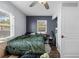 Bedroom featuring a large window providing natural light, and dark accent wall at 3503 Plaza Ave, Spring Hill, FL 34608