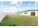 Large, green back yard with privacy fence and patio seating area at 38602 Finn Clover Ln, Zephyrhills, FL 33540