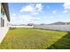 Spacious back yard features a privacy fence, lush grass, and patio at 38602 Finn Clover Ln, Zephyrhills, FL 33540