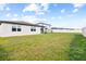 The spacious back yard features a privacy fence, grass, and patio at 38602 Finn Clover Ln, Zephyrhills, FL 33540
