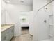 Bathroom showcasing modern shower, vanity, and a view into the Primary bedroom at 38602 Finn Clover Ln, Zephyrhills, FL 33540