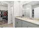 Bathroom featuring double sinks, granite countertops and a walk-in closet at 38602 Finn Clover Ln, Zephyrhills, FL 33540