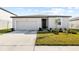 Beautiful single-Gathering home with a neat front lawn and attached two-car garage at 38602 Finn Clover Ln, Zephyrhills, FL 33540