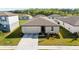 Charming single-story home with a well-maintained lawn and two-car garage in a quiet neighborhood at 38602 Finn Clover Ln, Zephyrhills, FL 33540