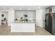 Spacious kitchen with light cabinets, stainless steel appliances, and large island at 38602 Finn Clover Ln, Zephyrhills, FL 33540