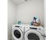 Bright laundry room with side-by-side Whirlpool washer and dryer at 38602 Finn Clover Ln, Zephyrhills, FL 33540