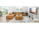 Comfortable living room with a plush sectional couch, TV, and an abundance of natural light at 38602 Finn Clover Ln, Zephyrhills, FL 33540