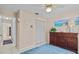 Bedroom with neutral walls, a dresser, double door closet and a blue rug at 39650 Us Highway 19 N # 244, Tarpon Springs, FL 34689