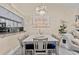 Cozy dining area featuring stylish furnishings, modern chandelier lighting, and access to kitchen view at 39650 Us Highway 19 N # 244, Tarpon Springs, FL 34689