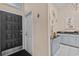 Inviting entryway with black front door, leading to a kitchen area with white cabinets and black countertop at 39650 Us Highway 19 N # 244, Tarpon Springs, FL 34689