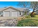 Charming single-story home featuring a two-car garage, landscaped yard, and welcoming front entrance at 39650 Us Highway 19 N # 244, Tarpon Springs, FL 34689