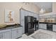 Spacious kitchen with black appliances, granite countertops, and elegant lighting fixtures with ample storage at 39650 Us Highway 19 N # 244, Tarpon Springs, FL 34689