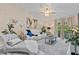 Comfortable living room with a white sofa, chaise lounge, and a sliding glass door leading to the outside at 39650 Us Highway 19 N # 244, Tarpon Springs, FL 34689
