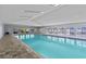 Indoor pool with lounge chairs on the deck and lots of natural light at 39650 Us Highway 19 N # 244, Tarpon Springs, FL 34689