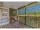 This home has a porch with a wood floor and view of foliage at 39650 Us Highway 19 N # 244, Tarpon Springs, FL 34689