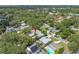 Aerial shot displays the home nestled among mature trees in a quiet residential area at 400 5Th S Ave, Safety Harbor, FL 34695