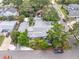 Aerial view of property with lush landscaping, hardscaped backyard and grey roof at 400 5Th S Ave, Safety Harbor, FL 34695