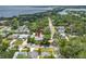 Aerial view showcases property surrounded by lush greenery and serene lake in the background at 400 5Th S Ave, Safety Harbor, FL 34695